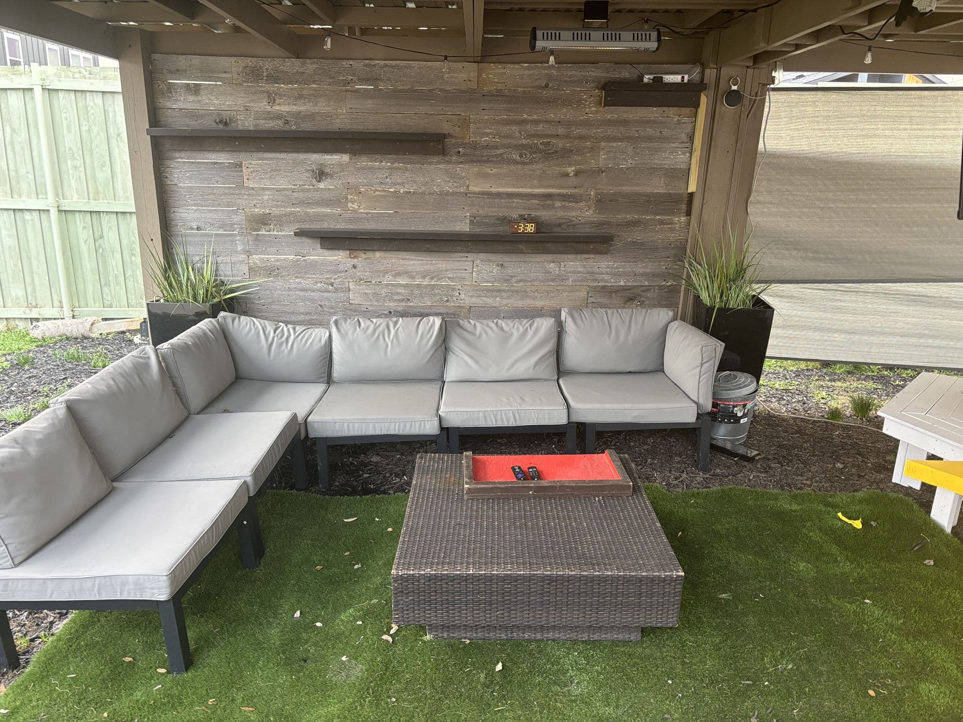 Outdoor sectional lounge under covered patio