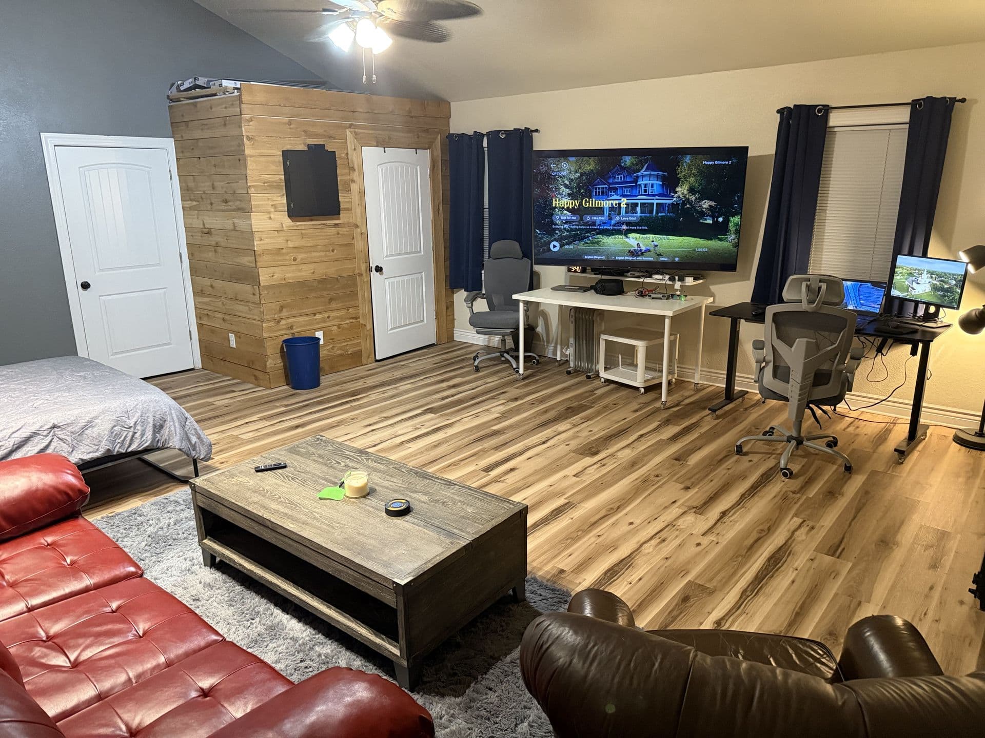 Interior workspace with large TV and desk setup