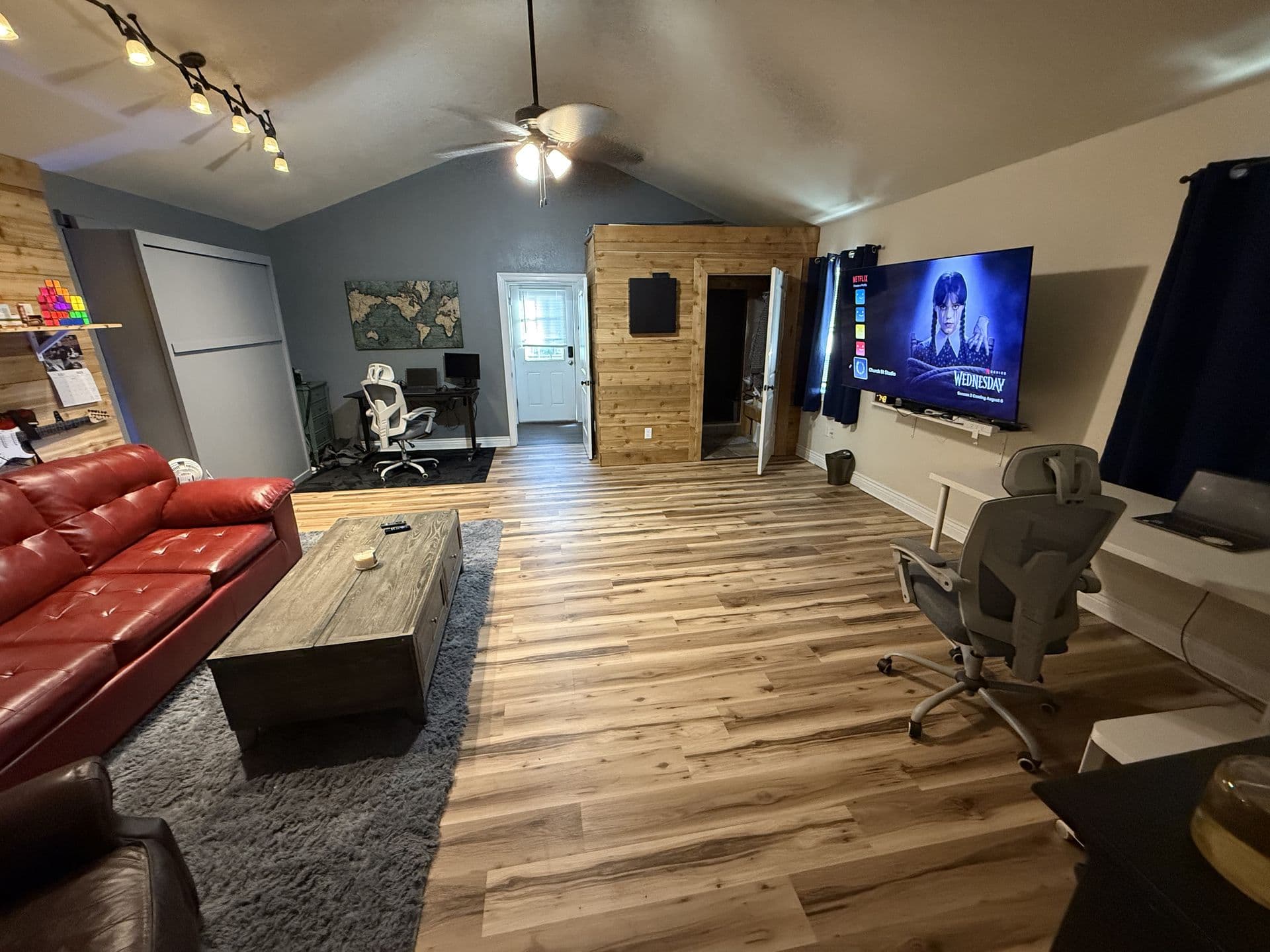 Open living space with entertainment setup and track lighting